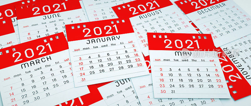 A pile of red 2021 calendar note pad pages spread around over each other